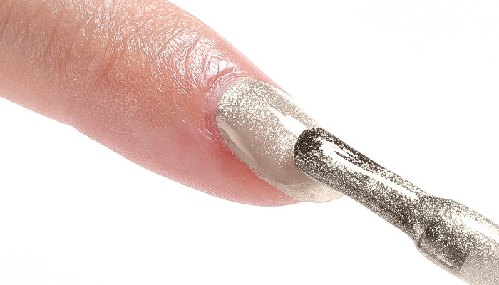 Layering shimmer gel nail polish evenly on natural nails for salon-quality finish
